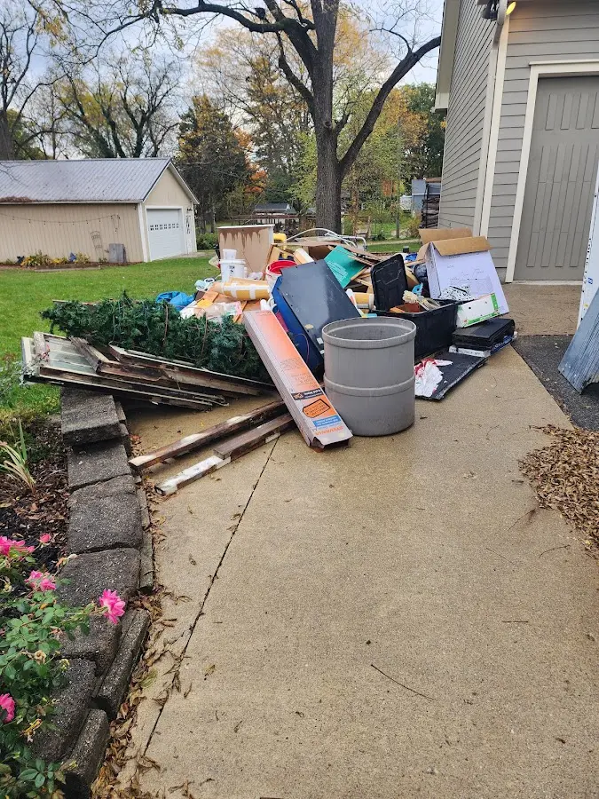 Dumpster being loaded with debris for 12 Yard Dumpster Rental in Saugatuck